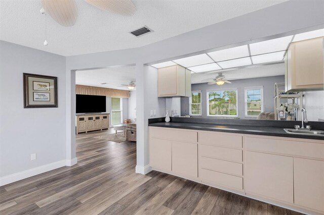 kitchen featuring cream cabinets, ceiling fan, sink, and hardwood / wood-style flooring