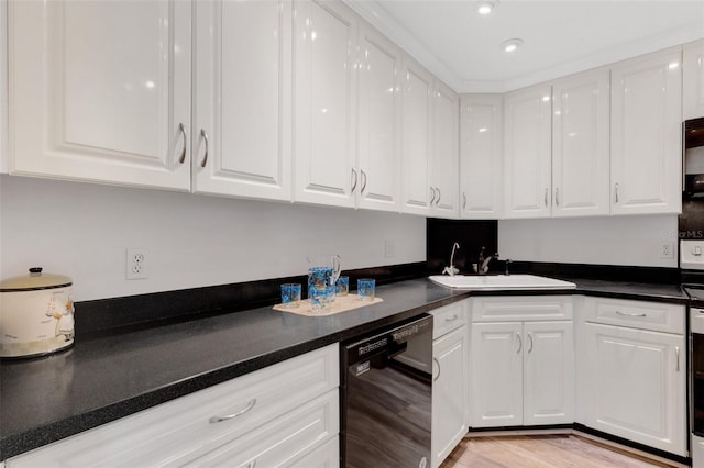 kitchen with black dishwasher, light hardwood / wood-style flooring, sink, and white cabinets