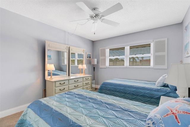 bedroom featuring a textured ceiling, carpet flooring, and ceiling fan