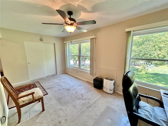 office with ceiling fan, light colored carpet, and a textured ceiling