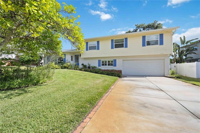 view of front of property with a front yard and a garage