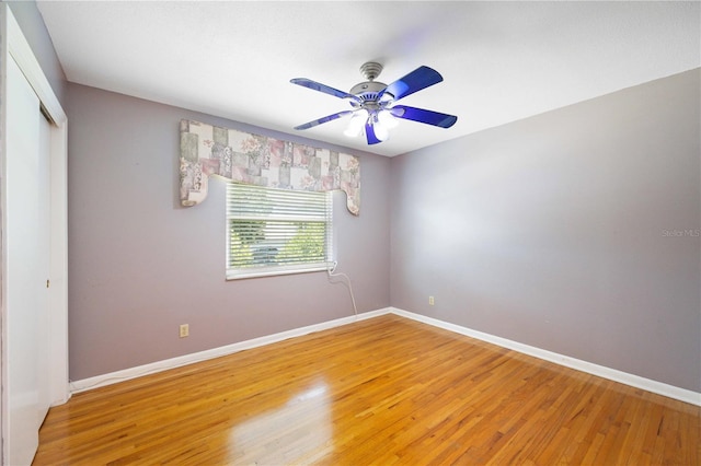 empty room featuring wood-type flooring and ceiling fan