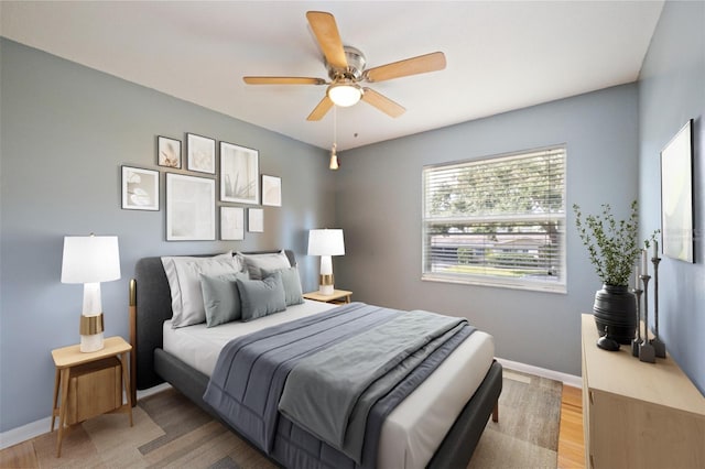 bedroom with ceiling fan and hardwood / wood-style flooring