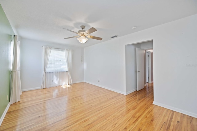 empty room featuring ceiling fan and light hardwood / wood-style flooring