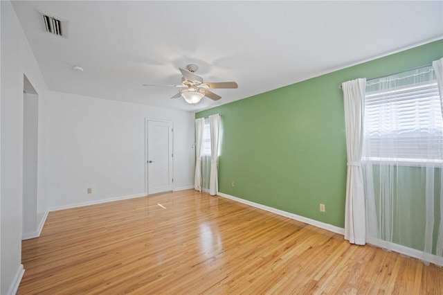 empty room with light hardwood / wood-style flooring and ceiling fan