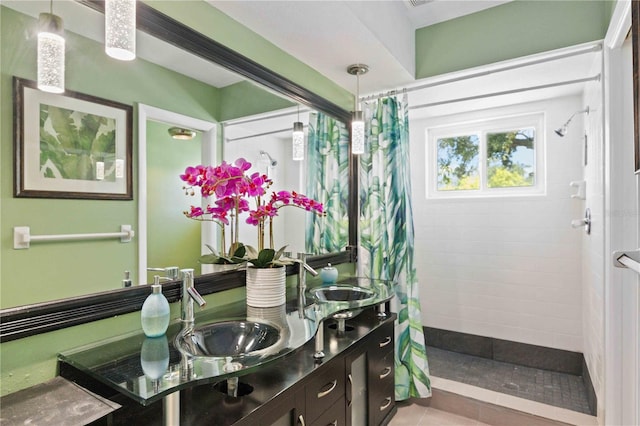 bathroom with tile patterned flooring, a shower with curtain, and vanity