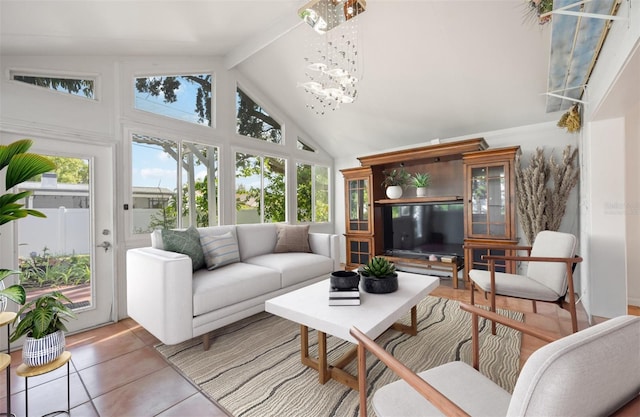 sunroom featuring lofted ceiling with beams and a chandelier