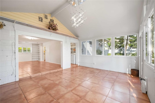 unfurnished sunroom with vaulted ceiling with beams, radiator, and an inviting chandelier