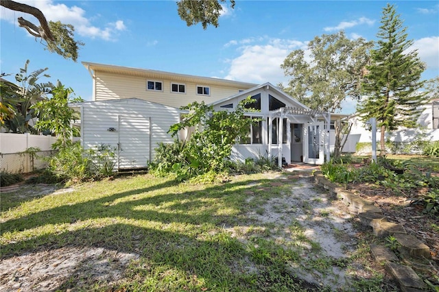 back of house featuring a yard