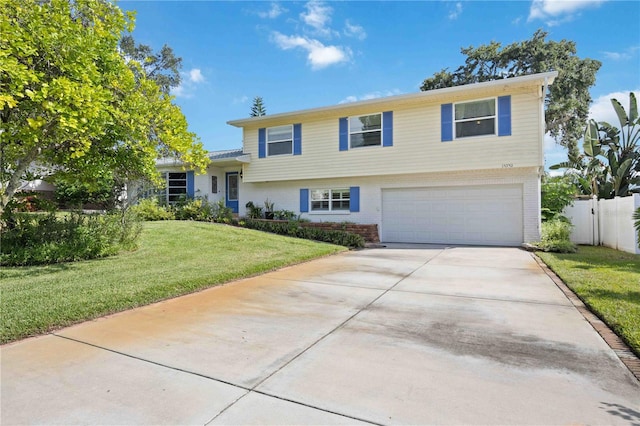 view of front of house with a garage and a front lawn