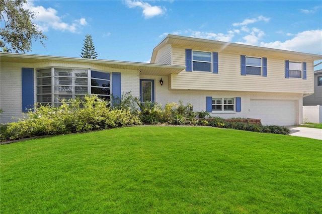 split level home with a garage and a front lawn