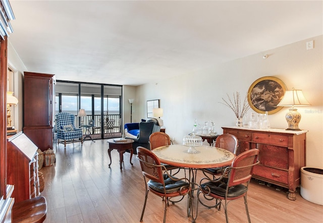 dining area featuring light hardwood / wood-style flooring and expansive windows