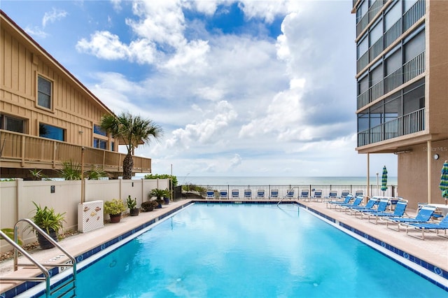 view of swimming pool featuring a water view