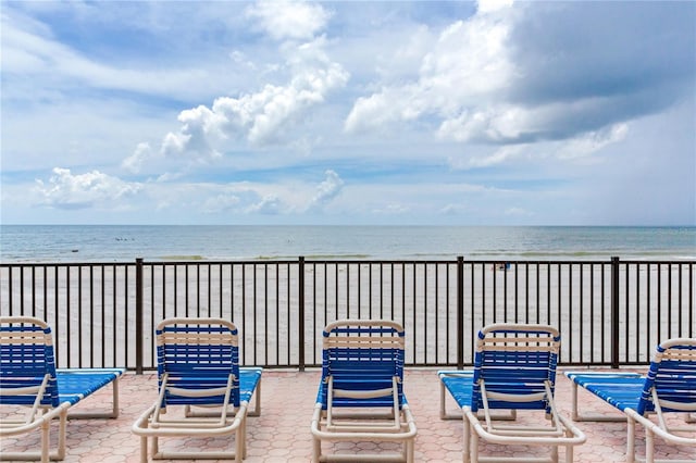 view of patio / terrace featuring a water view and a view of the beach