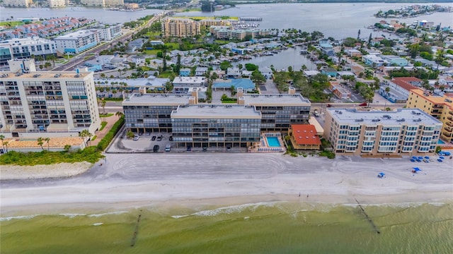 aerial view with a water view and a beach view