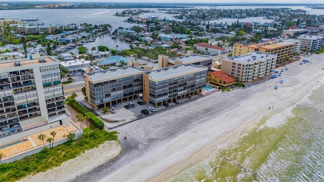 drone / aerial view featuring a beach view and a water view