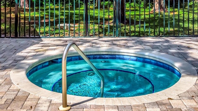 view of swimming pool with an in ground hot tub