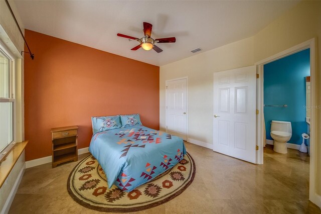 bedroom with ceiling fan and ensuite bath