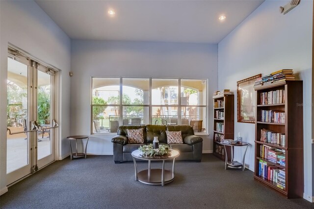 sitting room with french doors and dark colored carpet