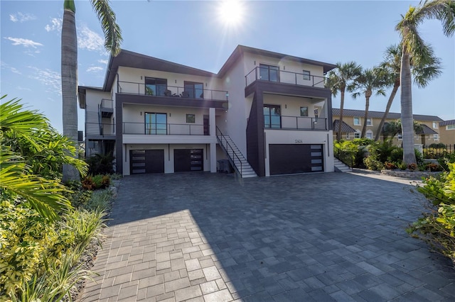 contemporary house featuring a balcony and a garage