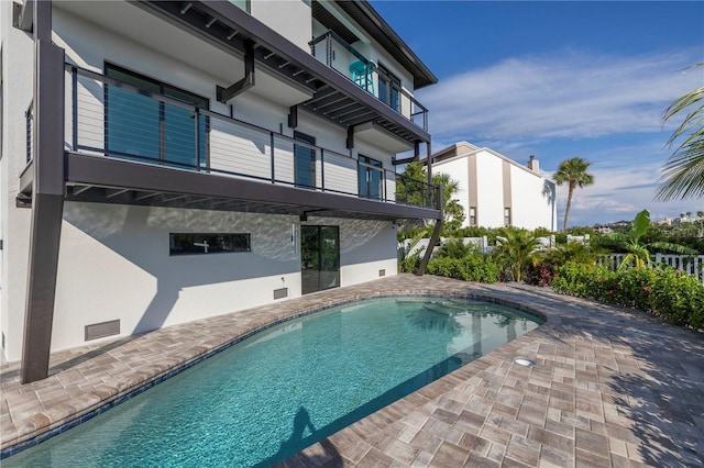 outdoor pool with a patio area