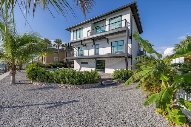 rear view of property with stucco siding