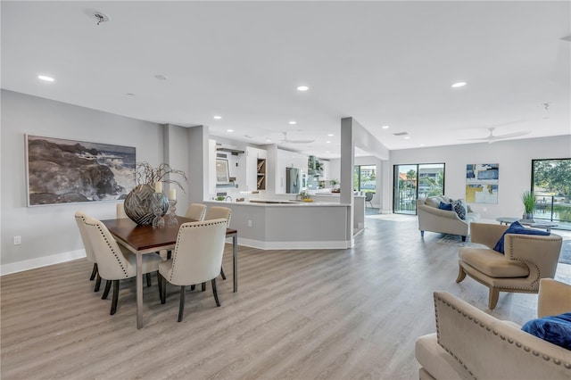 dining area featuring light wood-style floors, recessed lighting, ceiling fan, and baseboards