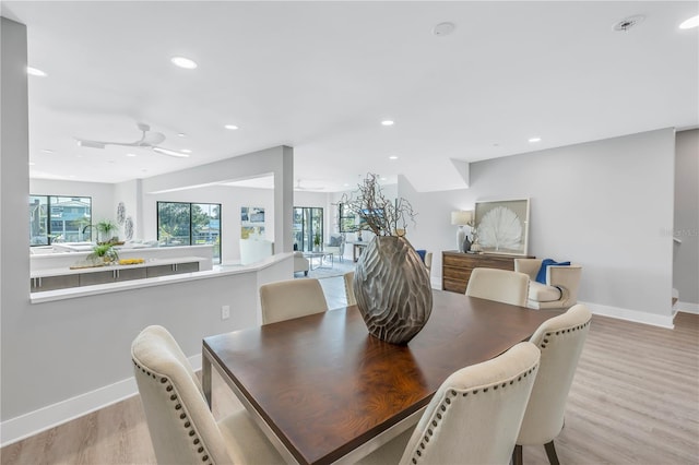 dining space with recessed lighting, a healthy amount of sunlight, light wood-style flooring, and baseboards