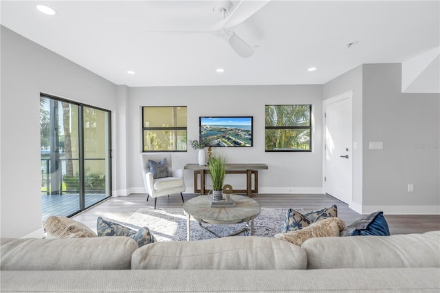 living room with recessed lighting, wood finished floors, and a healthy amount of sunlight