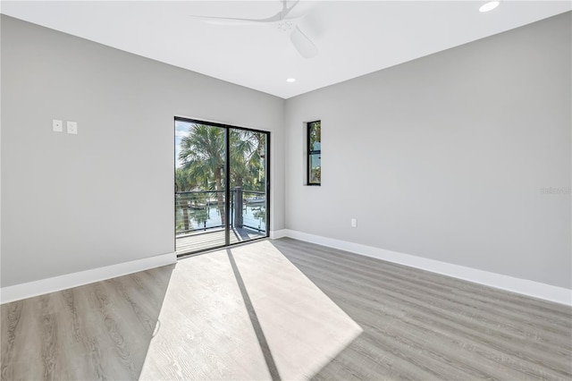 unfurnished room featuring a ceiling fan, recessed lighting, light wood-style flooring, and baseboards