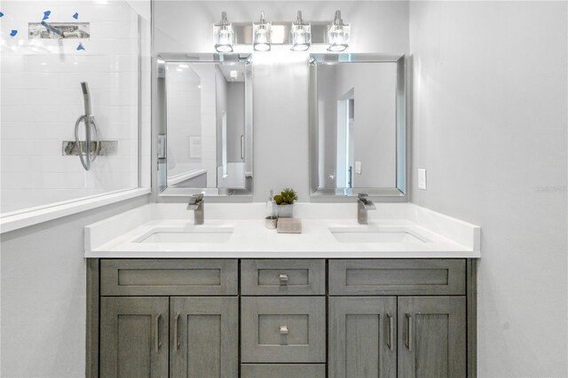 full bathroom with double vanity and a sink