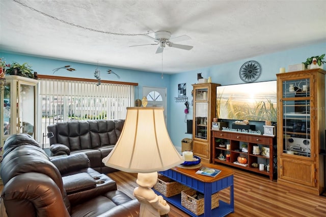 living room featuring a textured ceiling, ceiling fan, and hardwood / wood-style floors