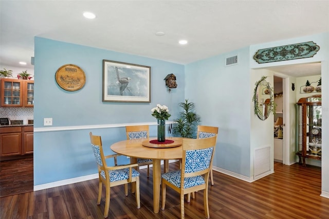 dining room with dark hardwood / wood-style flooring