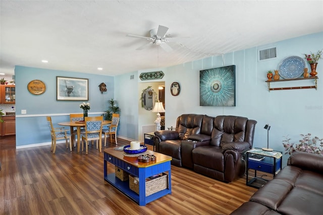 living room featuring ceiling fan and dark hardwood / wood-style flooring