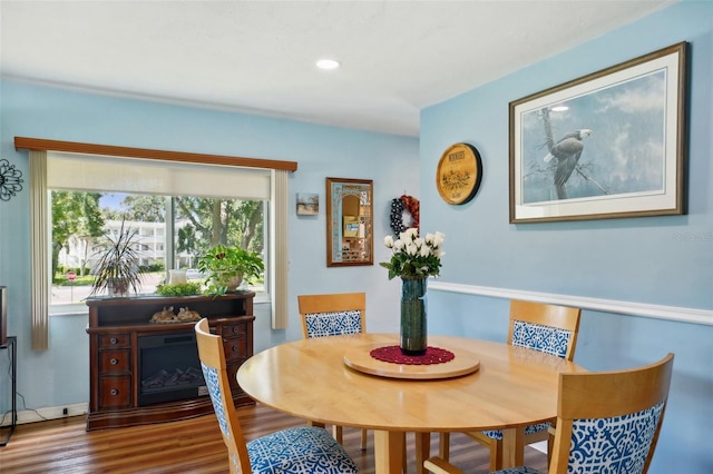 dining area with dark hardwood / wood-style flooring