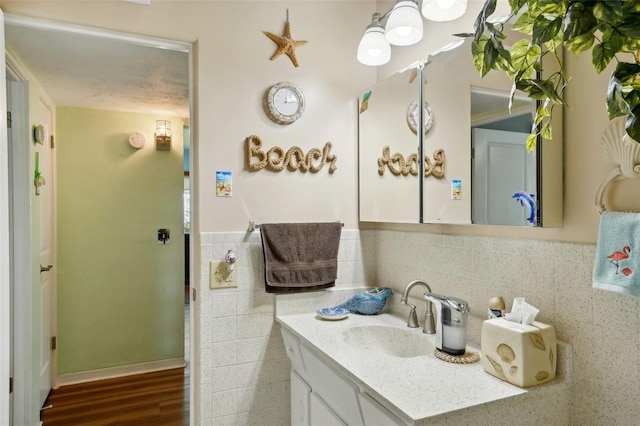 bathroom with tile walls, backsplash, vanity, and wood-type flooring