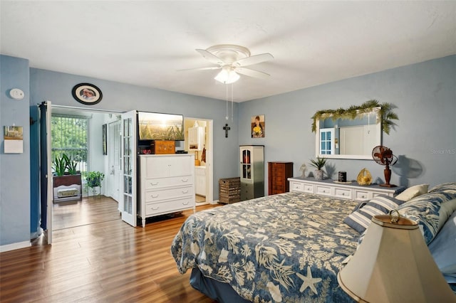 bedroom featuring hardwood / wood-style flooring, connected bathroom, and ceiling fan