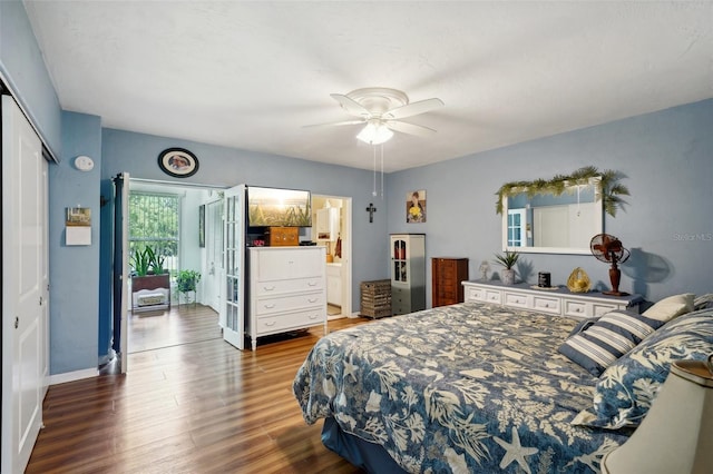 bedroom featuring dark wood-type flooring, ceiling fan, and a closet