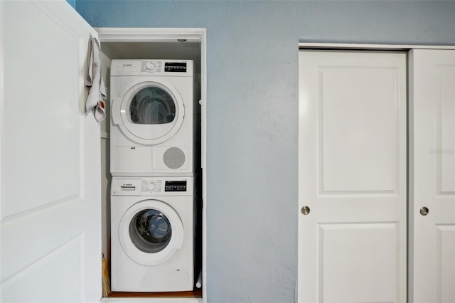 laundry area with stacked washing maching and dryer