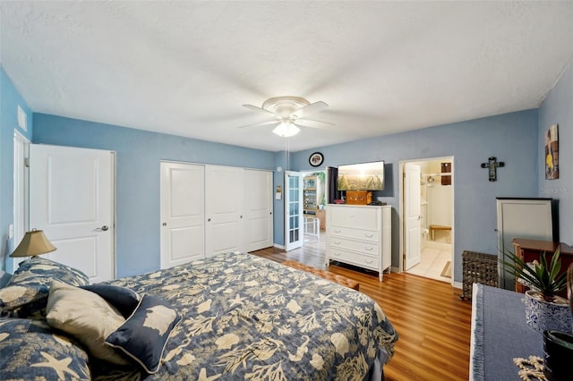 bedroom featuring ceiling fan, hardwood / wood-style flooring, and ensuite bathroom