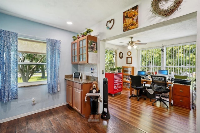 home office with dark hardwood / wood-style flooring and ceiling fan