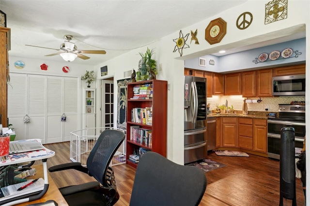 office space featuring dark hardwood / wood-style flooring and ceiling fan