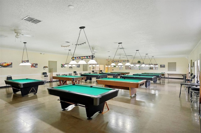 recreation room with a textured ceiling, billiards, concrete flooring, and ceiling fan