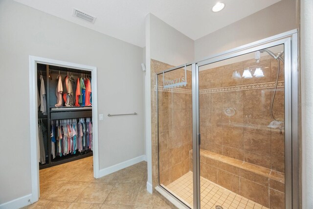 bathroom featuring walk in shower and tile patterned flooring