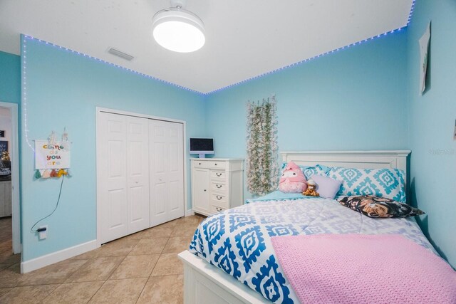 bedroom featuring a closet and light tile patterned floors