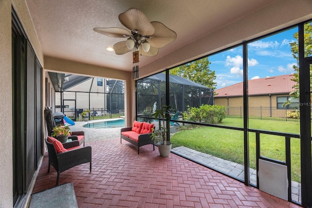 sunroom / solarium featuring a pool and ceiling fan