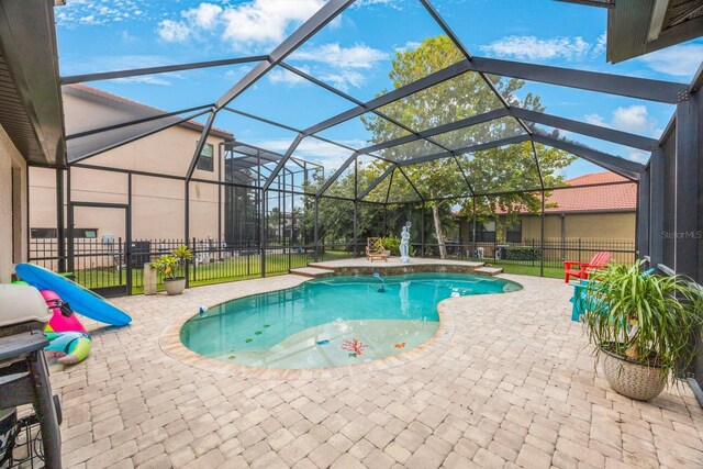 view of pool with a patio area and a lanai