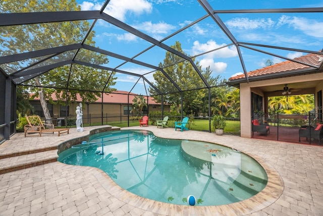 view of pool with a patio, a lanai, and ceiling fan