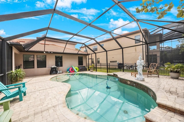 view of swimming pool with a patio area and glass enclosure