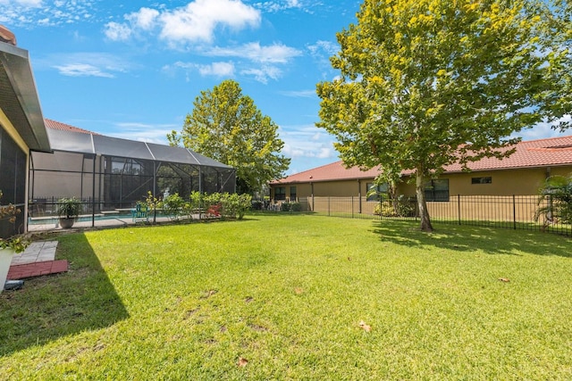 view of yard with a fenced in pool and a lanai